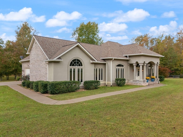 rear view of house with a garage and a lawn