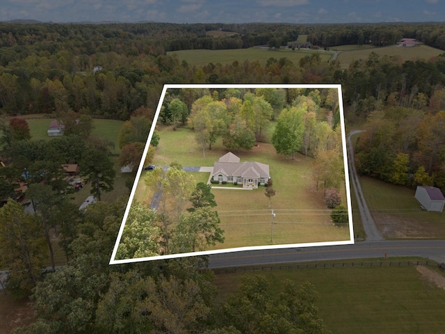 birds eye view of property with a rural view