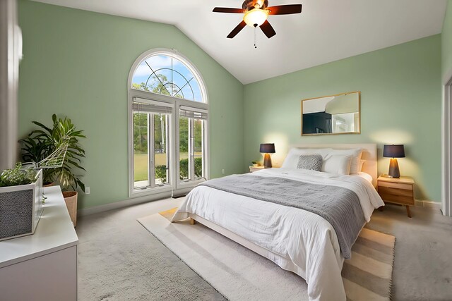 bedroom with ceiling fan, lofted ceiling, and light colored carpet