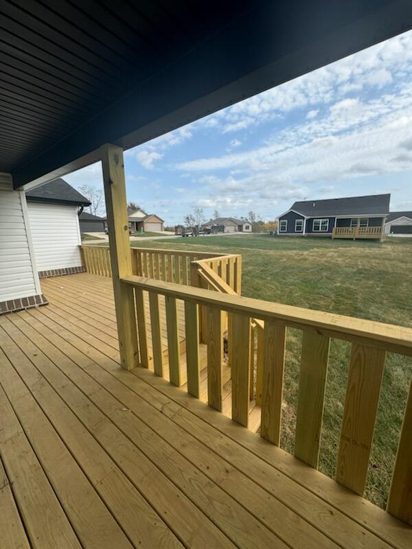 wooden terrace featuring a yard