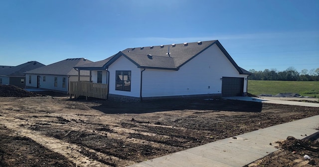 view of side of home featuring a garage