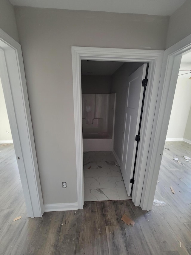 hallway with wood-type flooring