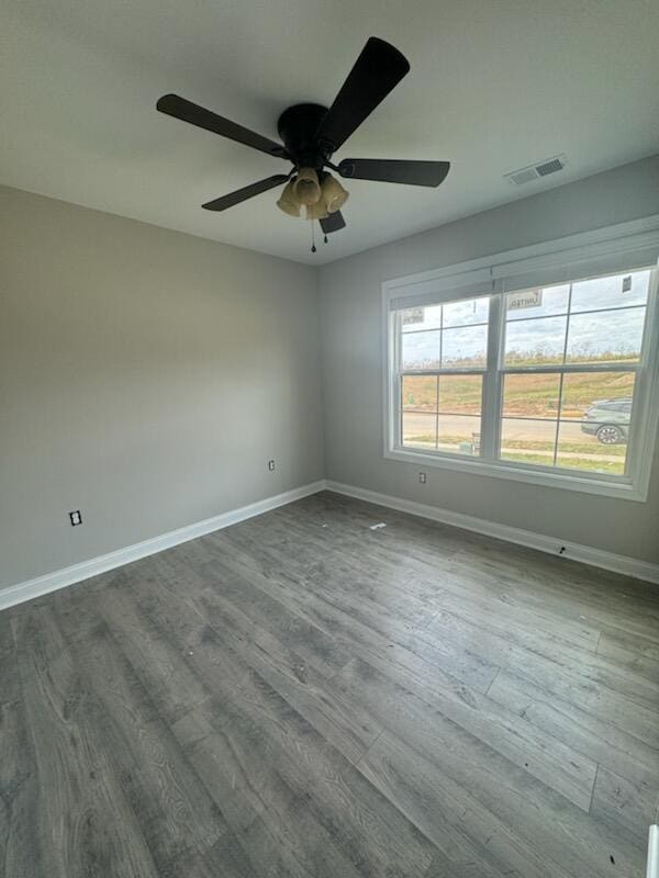 spare room with hardwood / wood-style floors and ceiling fan