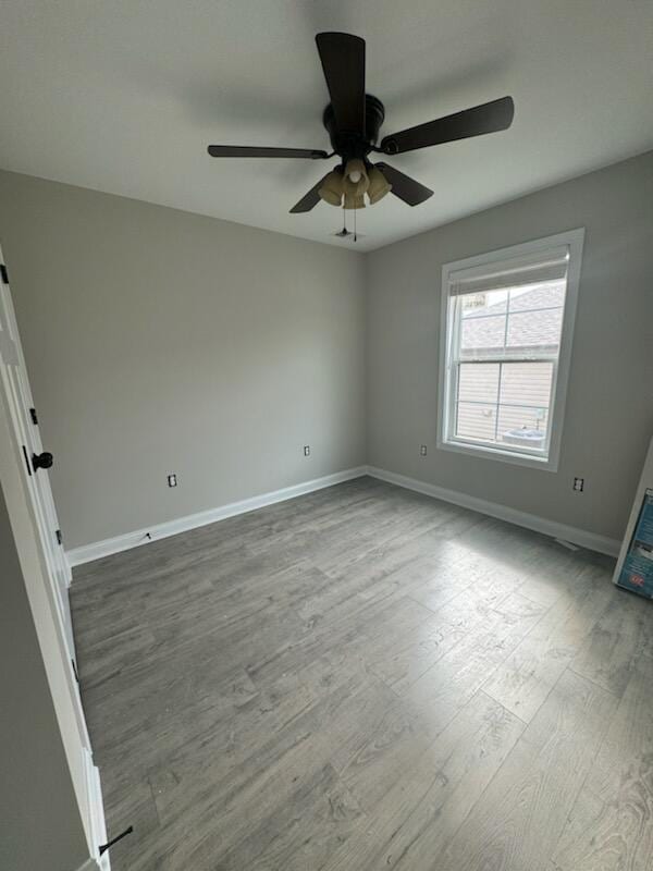 spare room with wood-type flooring and ceiling fan