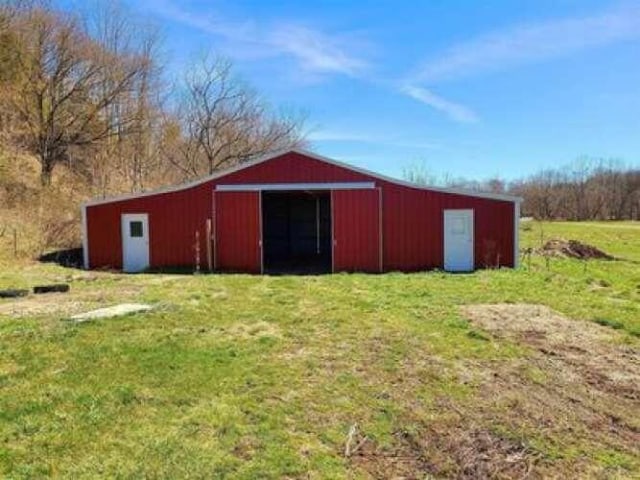 view of pole building with a yard