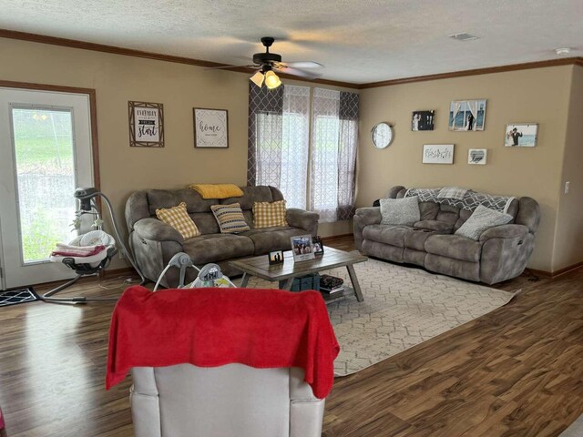 living room with crown molding, a textured ceiling, ceiling fan, and dark hardwood / wood-style floors