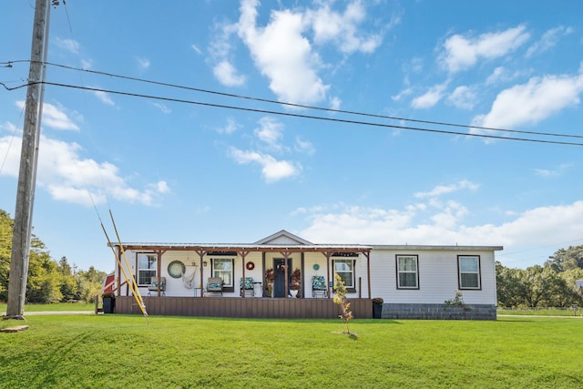 manufactured / mobile home featuring a front lawn and a porch