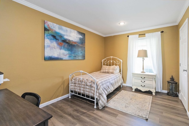 bedroom with crown molding and hardwood / wood-style flooring