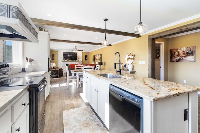 kitchen featuring pendant lighting, white cabinetry, stainless steel range with electric cooktop, sink, and black dishwasher