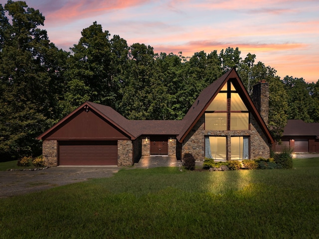 view of front of property with a yard and a garage