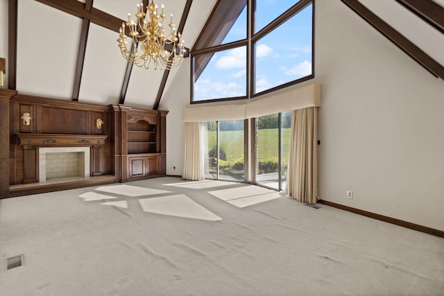 unfurnished living room with an inviting chandelier, high vaulted ceiling, beamed ceiling, and carpet flooring