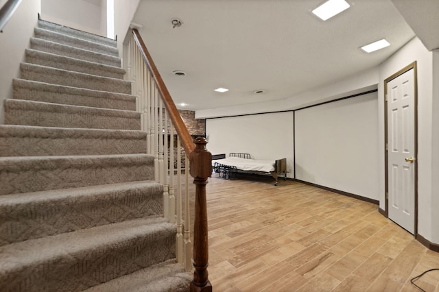 staircase featuring hardwood / wood-style floors