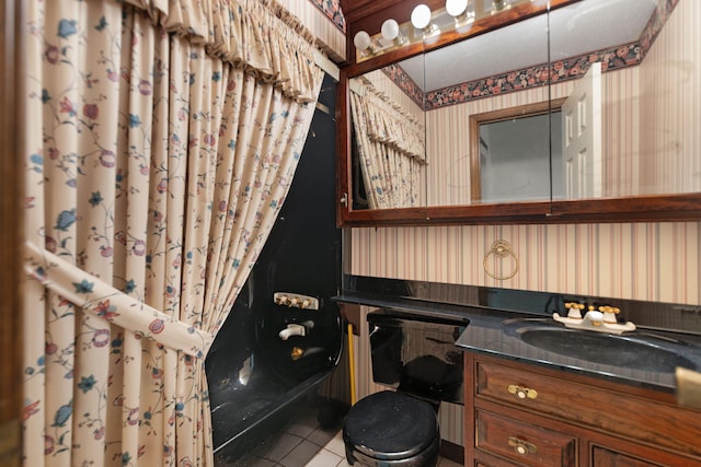 bathroom featuring tile patterned flooring, vanity, and toilet