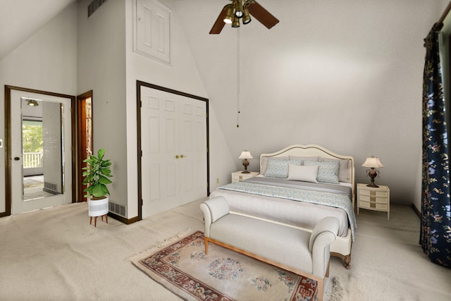 carpeted bedroom with high vaulted ceiling, ceiling fan, and a closet