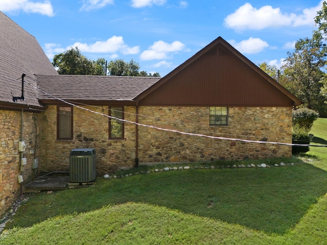 view of home's exterior featuring central AC and a lawn