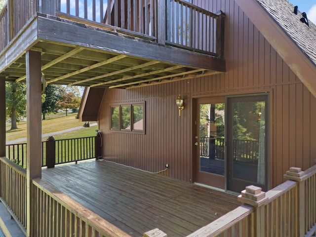 wooden terrace featuring a lawn