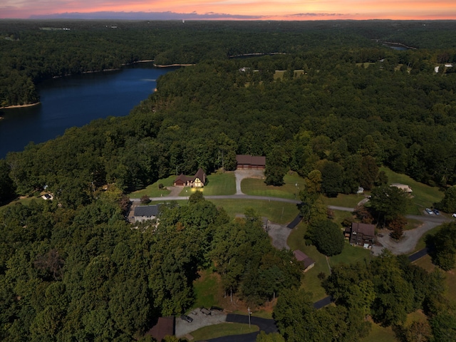 aerial view at dusk featuring a water view