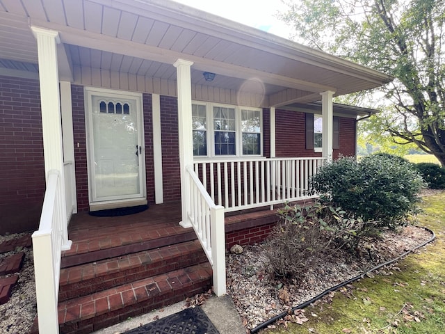 entrance to property featuring a porch