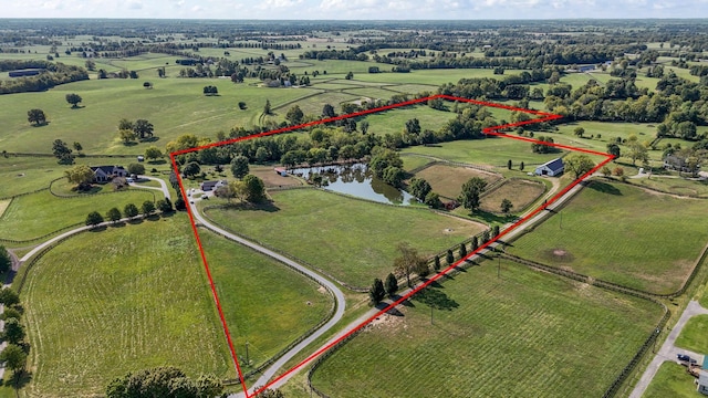 birds eye view of property with a rural view and a water view