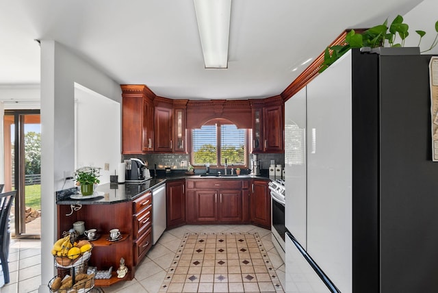 kitchen with light tile patterned floors, stainless steel appliances, sink, and tasteful backsplash