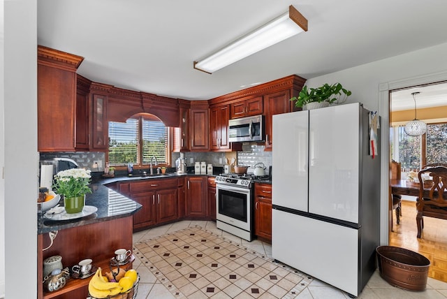 kitchen featuring light tile patterned floors, appliances with stainless steel finishes, tasteful backsplash, and sink