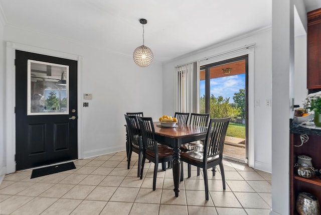 dining area with light tile patterned floors and crown molding