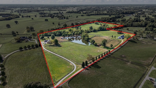 birds eye view of property featuring a water view and a rural view