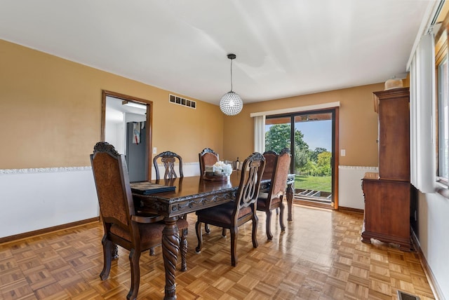 dining area with parquet flooring