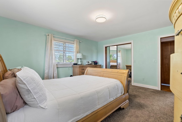 bedroom featuring a closet and dark colored carpet