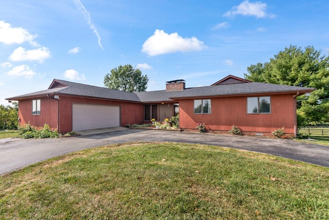 single story home featuring a front yard and a garage