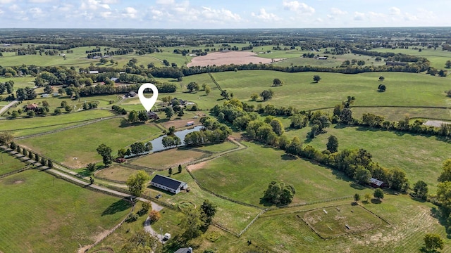 birds eye view of property with a water view and a rural view