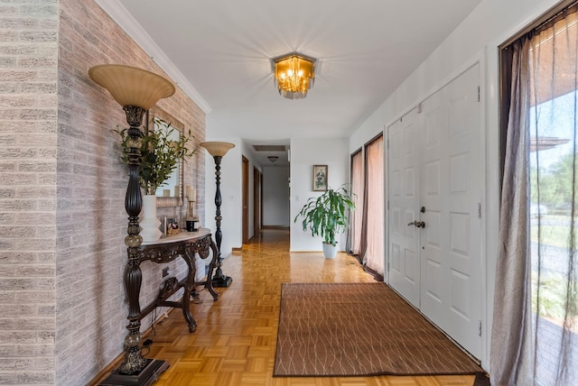 entrance foyer with light parquet flooring, a healthy amount of sunlight, and an inviting chandelier