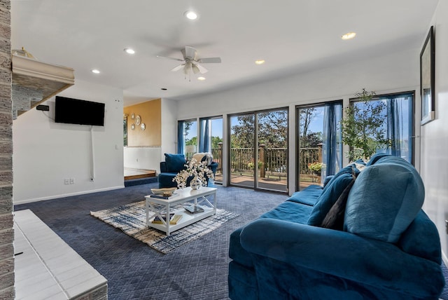 living room featuring ceiling fan and dark carpet