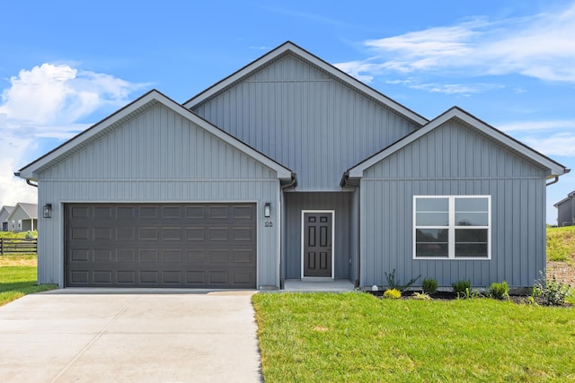 single story home featuring a front yard, a garage, and driveway