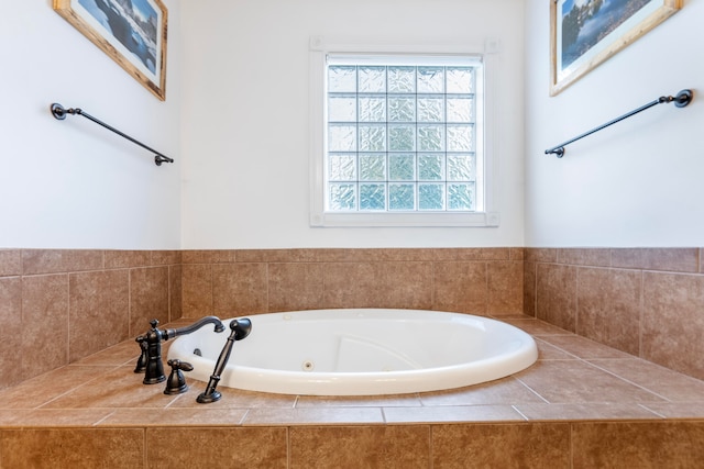 bathroom with a wealth of natural light and tiled bath