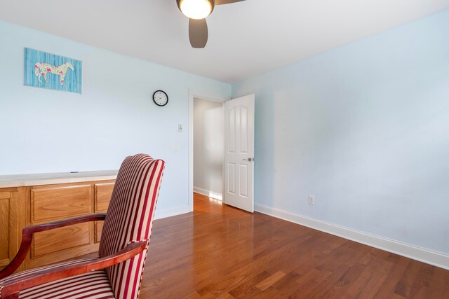 home office featuring dark wood-type flooring and ceiling fan