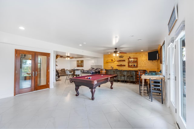 rec room featuring bar, pool table, plenty of natural light, and french doors