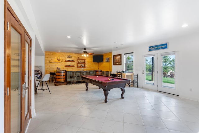 rec room featuring billiards, ceiling fan, indoor bar, and wooden walls