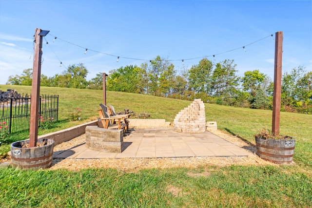 view of yard with a fire pit and a patio