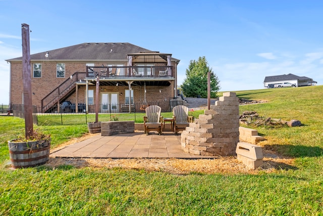 back of property featuring a lawn, a patio area, and a deck