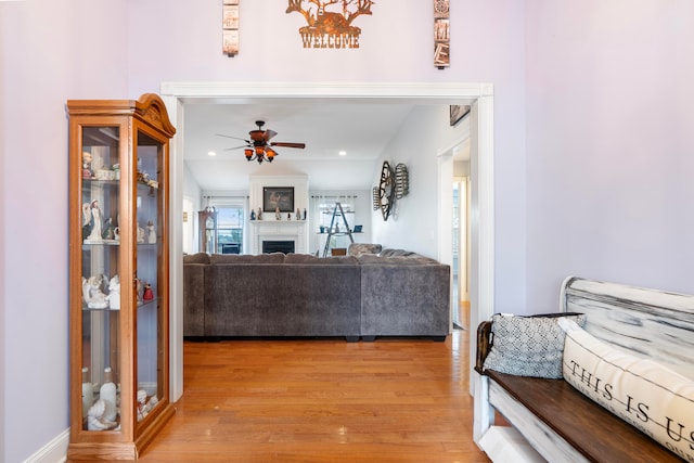 living room featuring light wood-type flooring and ceiling fan