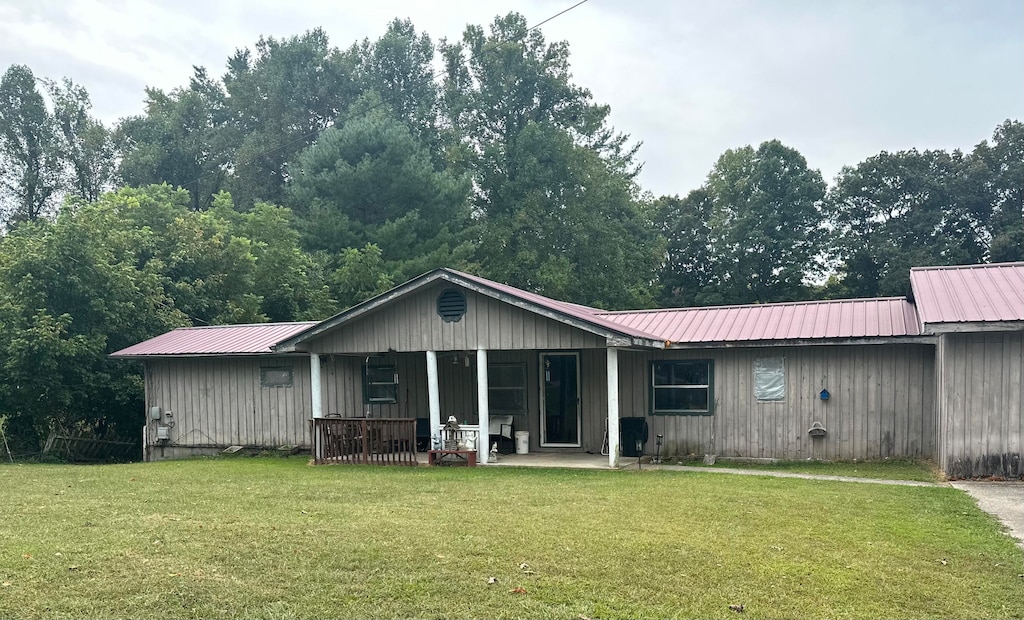 back of property featuring a yard