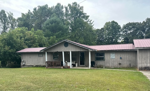 back of property featuring a yard