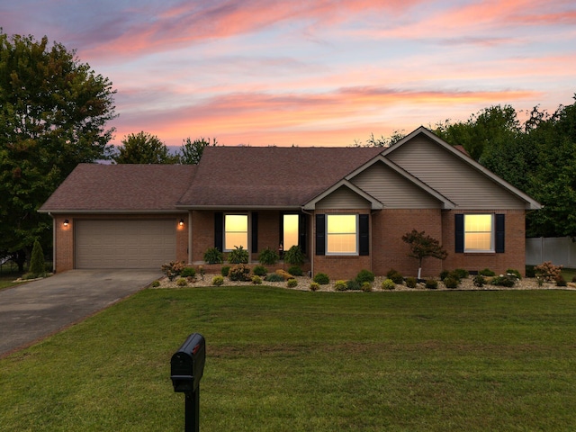 ranch-style house with a yard and a garage