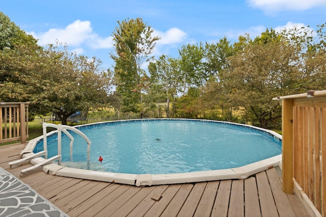 view of swimming pool featuring a wooden deck