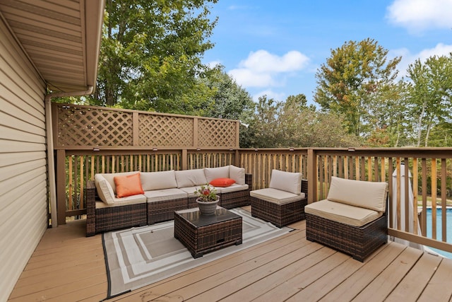 wooden terrace with a swimming pool and an outdoor hangout area