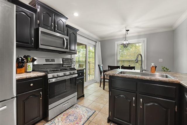 kitchen featuring ornamental molding, decorative light fixtures, sink, appliances with stainless steel finishes, and light tile patterned flooring