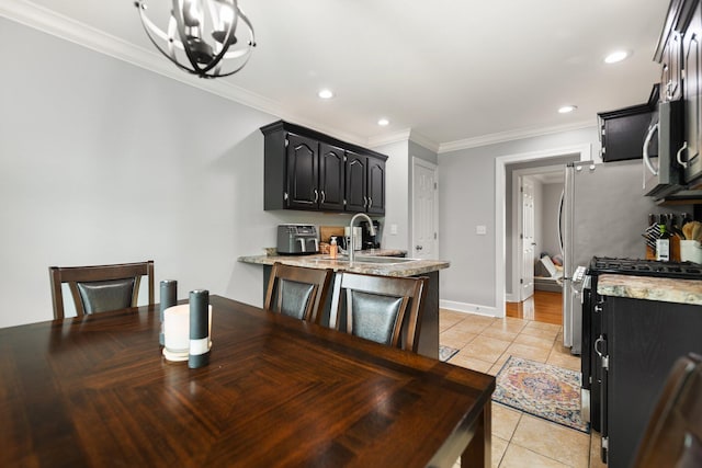 tiled dining space with ornamental molding, sink, and a notable chandelier