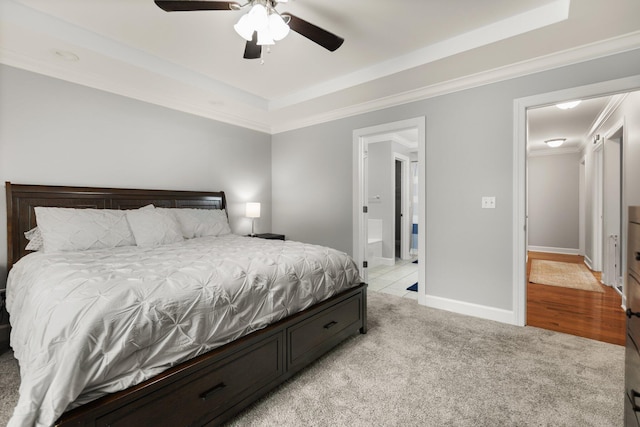 bedroom with light carpet, a raised ceiling, crown molding, and ceiling fan