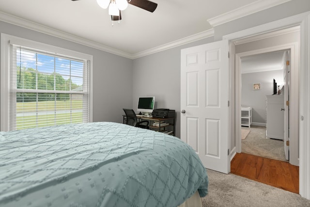 bedroom with ornamental molding, light hardwood / wood-style flooring, and ceiling fan